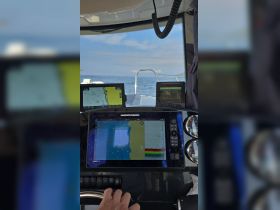 The helm of a boat featuring advanced navigation displays, showcasing the control center for an exciting day on the water.