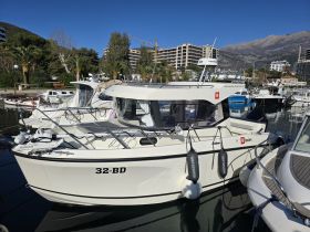 A pristine view of a yacht docked in a marina, showcasing its sleek design and surrounding boats — perfect for exploring coastal destinations.