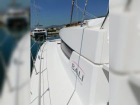 A sleek view of a Bali catamaran docked at the marina, showcasing its modern design and pristine condition.