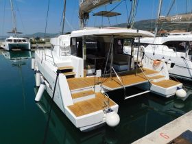 A sleek catamaran docked in calm waters, showcasing its modern design and spacious deck — perfect for luxury sailing experiences.