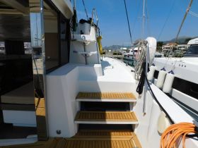 A well-designed interior view of a yacht showcasing the helm and seating area, perfect for comfortable cruising and relaxation.