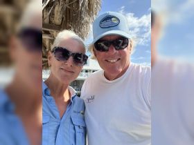 A cheerful couple poses for a selfie, showcasing their enthusiasm for boat tours. Perfect for capturing memorable moments before embarking on an adventure.