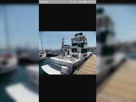A clear view of the 'Kamryn Dawson' boat docked at the marina, showcasing its structure and design.