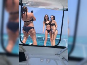 A fun group of friends poses for a photo on a boat, enjoying the sun and sea in stylish bikinis — perfect for summer adventures and memorable outings.