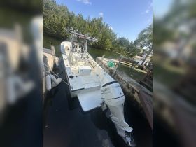 A well-equipped center console boat docked in a serene waterway, showcasing its sleek design and fishing gear — perfect for a day out on the water.