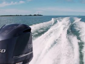 A close-up view of a Yamaha outboard motor in action, leaving a wake on the water — perfect for showcasing boating adventures.