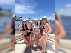 A lively group of friends celebrates a bachelorette party aboard a pontoon boat, showcasing fun and camaraderie under the sunny skies.