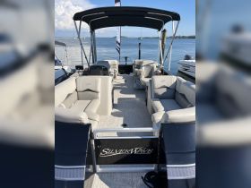 Interior view of a SilverWave pontoon boat showcasing spacious seating and a stylish design, perfect for relaxing on the water.