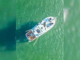 Aerial view of a group enjoying time aboard a boat, showcasing the vibrant turquoise waters below — perfect for a day of relaxation and fun on the water.