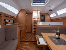 Interior view of a modern boat cabin featuring comfortable seating and a well-equipped helm, perfect for relaxing and enjoying time on the water.