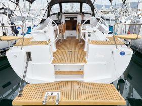 A detailed view of the helm and interior of a yacht, showcasing the elegant wooden flooring and modern design, perfect for comfortable sailing experiences.