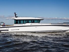 A sleek Axopar speedboat cruising through the water, showcasing its modern design and performance on the open sea.