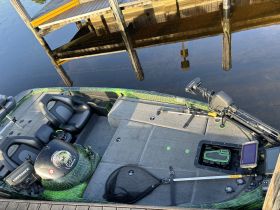Interior view of a fishing boat showcasing comfortable seating and modern equipment, perfect for a day on the water.