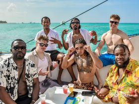 A lively group of friends enjoys drinks and camaraderie aboard a boat, capturing the essence of a fun-filled day on the water.