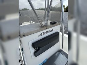 A close-up view of the helm area on a boat, showcasing the console and seating — perfect for navigating the waterways.