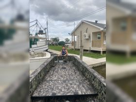 A child sits on a fishing boat at the dock, ready for a day of adventure on the water. This scene captures the excitement of boating and fishing experiences.