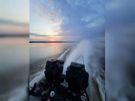 A stunning sunset view from the perspective of a speeding boat, showcasing the tranquil waters and vibrant sky — perfect for adventure seekers and nature lovers.