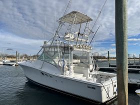A sleek fishing yacht docked at the marina, showcasing its impressive structure and design, perfect for fishing enthusiasts.