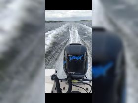 A close-up view of a Yamaha VMAX outboard motor in action, leaving a wake on the water — perfect for showcasing the power and performance of boating.