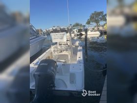 A well-equipped charter fishing boat docked and ready for island tours, showcasing its features and signage for fishing trips.