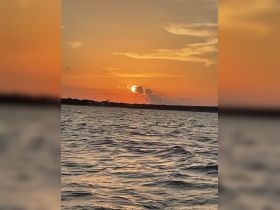 A stunning sunset over the water, casting a warm glow on the waves — perfect for capturing the beauty of evening boat trips.