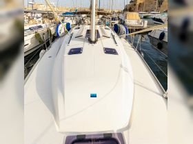 Aerial view of a sleek yacht docked in a marina, showcasing its elegant design and structure — perfect for luxury sailing experiences.