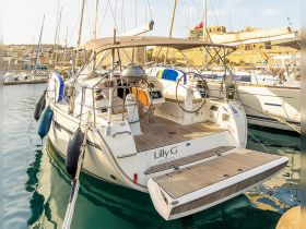 A beautiful view of the 'Lilly G' yacht docked in a serene harbor, showcasing its elegant design and inviting atmosphere.