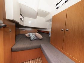 Cozy interior cabin of a boat featuring comfortable seating and storage, perfect for relaxing during your nautical adventures.