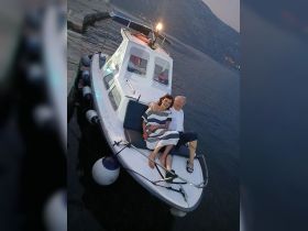 A couple enjoys a romantic moment on a boat at sunset, creating the perfect backdrop for unforgettable memories on the water.