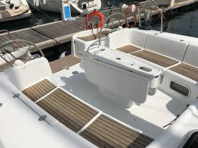A clean and spacious interior view of a boat's seating and helm area, showcasing the perfect setup for relaxation and navigation.