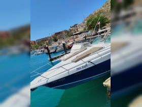 A sleek yacht named 'Mi Sofi' docked in a vibrant marina, showcasing the beautiful turquoise waters and surrounding scenery.