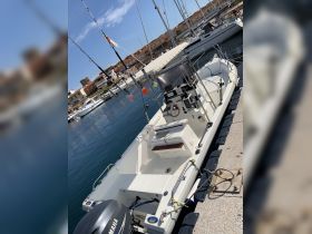 A well-equipped center console boat docked at the marina, showcasing its sleek design and fishing gear — perfect for a day on the water.