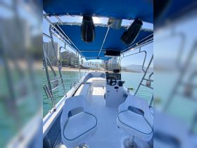 Interior view of a boat's helm and seating area, showcasing a clean and functional design ideal for cruising or fishing trips.
