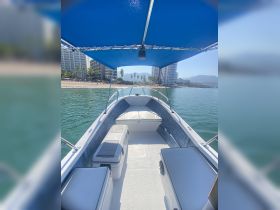 Interior view of a boat showcasing comfortable seating and storage, perfect for a day out on the water.