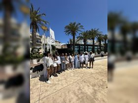 A vibrant group of friends poses together in a sunny outdoor setting, perfect for celebrations and memorable moments.