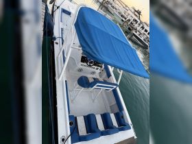 Interior view of a boat showcasing comfortable seating and a helm area, perfect for a day on the water.