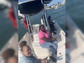 A lively group enjoys a fishing trip aboard a boat, showcasing camaraderie and fun on the water.