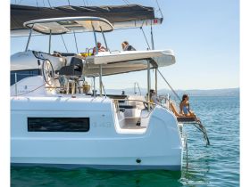 Guests enjoy a relaxing moment on a catamaran, soaking in the sun and the serene waters — perfect for leisure and adventure on the open sea.