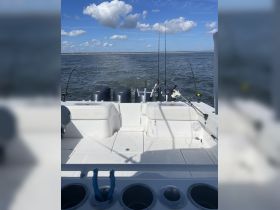 View of the fishing helm on a boat, showcasing the console and fishing gear, perfect for a day out on the water.