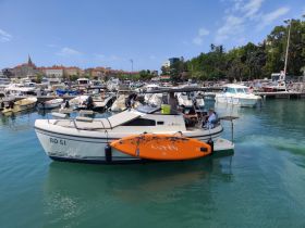 A lively scene at the marina with a boat and people enjoying their time, showcasing the vibrant atmosphere of a boating adventure.