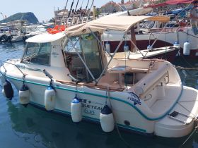 A well-equipped fishing boat docked in a marina, showcasing its structure and features, perfect for fishing enthusiasts.