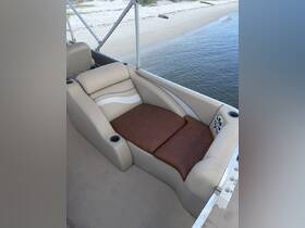 A cozy seating area inside a boat, featuring comfortable cushions and cup holders, perfect for relaxing while enjoying a day on the water.