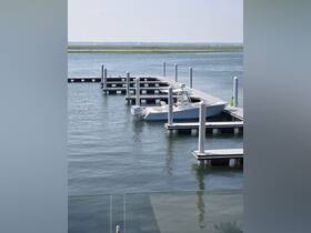 A serene view of a boat docked at a marina, showcasing the calm waters and well-maintained docking facilities, perfect for boating enthusiasts.