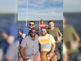 A group of friends enjoys a fun day on the water, capturing the essence of friendship and celebration aboard a boat.