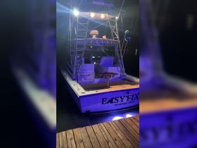 A well-lit view of the interior helm of the 'EASYFIX' boat, showcasing its seating and control area, perfect for nighttime excursions on the water.