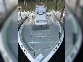 A sleek speedboat named 'Salty Frog' docked at the marina, showcasing its modern design and spacious deck — perfect for fishing or leisure outings.