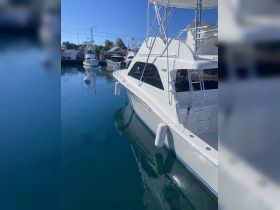 A sleek yacht docked in calm waters, showcasing its elegant design and reflections — perfect for luxury boating experiences.