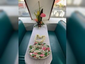 A beautifully arranged table featuring decorative cookies and floral accents, perfect for a birthday celebration aboard a boat.