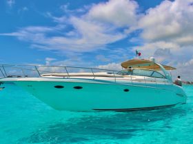 A stunning yacht glides through crystal-clear turquoise waters, showcasing its sleek design and elegance — perfect for luxury outings on the sea.