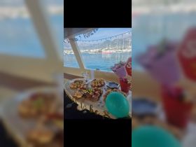 A beautifully arranged spread of food and drinks on a boat, perfect for celebrations or gatherings while enjoying scenic views.